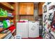 Functional laundry room with washer, dryer, storage, and built-in shelving for efficient organization at 914 Forest Dr, Garner, NC 27529