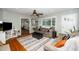 Bright and open living room with hardwood floors, comfortable seating, and large windows at 914 Forest Dr, Garner, NC 27529