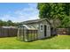 Charming green backyard outbuilding featuring a greenhouse attachment, perfect for gardening enthusiasts at 914 Forest Dr, Garner, NC 27529