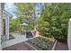 Landscaped backyard features a dining set under an umbrella and a flower bed at 9530 Vira Dr, Raleigh, NC 27617