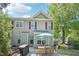 Spacious backyard featuring a dining set, barbecue, and flower bed with an expansive view of the house at 9530 Vira Dr, Raleigh, NC 27617