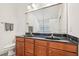 Bathroom showcasing a vanity with dual sinks and a large mirror at 9530 Vira Dr, Raleigh, NC 27617