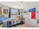 Bright bedroom featuring a window, personal decorations, and carpeted floors at 9530 Vira Dr, Raleigh, NC 27617