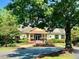 The clubhouse is surrounded by manicured landscaping and a circular flower garden at 9530 Vira Dr, Raleigh, NC 27617