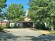 A well-maintained clubhouse with a grand entrance surrounded by trees and landscaping for community gatherings and events at 9530 Vira Dr, Raleigh, NC 27617