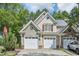 Spacious two-car garage featuring white doors and unique round windows in the gables at 9530 Vira Dr, Raleigh, NC 27617