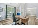 Bright home office with wood floors, a computer desk, and direct view into the dining area at 9530 Vira Dr, Raleigh, NC 27617