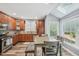 Bright eat-in kitchen with wood cabinets, stainless appliances, and skylight at 9530 Vira Dr, Raleigh, NC 27617