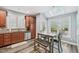 Bright eat-in kitchen featuring skylight, wood cabinets, stainless steel appliances, and a dining table with bench seating at 9530 Vira Dr, Raleigh, NC 27617
