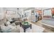 Spacious living room featuring a large sofa, ottoman, and view into the kitchen at 9530 Vira Dr, Raleigh, NC 27617