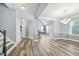 Open living space with dining area, staircase, light gray walls, wood-look floors, and natural light at 9530 Vira Dr, Raleigh, NC 27617