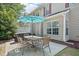 Outdoor patio area with dining set, grill, and well-maintained backyard of a two-story home at 9530 Vira Dr, Raleigh, NC 27617