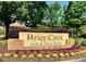 Brier Creek Swim & Tennis Pavilion signage framed by manicured landscaping with colorful flowers at 9530 Vira Dr, Raleigh, NC 27617