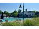 A resort-style swimming pool with lounge chairs, a clubhouse, and well-maintained landscaping for relaxation and recreation at 9530 Vira Dr, Raleigh, NC 27617
