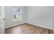 Bedroom with wood flooring, a window, and ample natural light at 9612 Treymore Dr, Raleigh, NC 27617