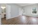 Light-filled bedroom with wood floors, large windows, and ensuite bathroom at 9612 Treymore Dr, Raleigh, NC 27617