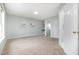 Spacious bedroom with carpet, light blue walls, and an open door to another room at 9612 Treymore Dr, Raleigh, NC 27617