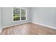Bedroom featuring hardwood floors and a window with a pleasant view at 9612 Treymore Dr, Raleigh, NC 27617