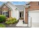 Close-up of the front exterior showcasing the entrance, brick accents, and landscaping at 9612 Treymore Dr, Raleigh, NC 27617