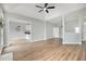 Open-concept living space with hardwood floors, views to the kitchen, and a fireplace at 9612 Treymore Dr, Raleigh, NC 27617