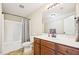 Clean bathroom with a shower-tub combo, neutral tile, and a vanity with wood cabinetry at 1004 Lake Michael Way, Mebane, NC 27302