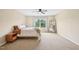 Carpeted bedroom features a bed, nightstand, a mirror, and a window that offers great natural light at 1004 Lake Michael Way, Mebane, NC 27302