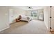Spacious bedroom with plush carpeting, ceiling fan, and a sunlit window overlooking trees at 1004 Lake Michael Way, Mebane, NC 27302