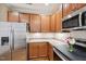 Well-lit kitchen featuring granite countertops, wood cabinets, and stainless steel appliances at 1004 Lake Michael Way, Mebane, NC 27302