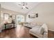 Bright living room with hardwood floors, a ceiling fan, large windows, and a comfortable sectional sofa at 1004 Lake Michael Way, Mebane, NC 27302