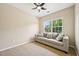 Living room with plush carpeting and a gray couch with decorative pillows in a naturally lit room at 1004 Lake Michael Way, Mebane, NC 27302