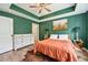 Bright primary bedroom featuring hardwood floors, tray ceilings, and generous closet space at 1004 Lake Michael Way, Mebane, NC 27302