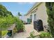 Outdoor patio area with lush plants and garden, plus covered grill, offering a relaxing space at 1004 Lake Michael Way, Mebane, NC 27302