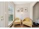 Bright sitting area showcasing hardwood floors, natural light, and charming decorative accents at 1004 Lake Michael Way, Mebane, NC 27302