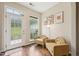 Cozy sitting area with large windows, natural light, hardwood floors, and comfortable armchairs at 1004 Lake Michael Way, Mebane, NC 27302