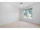 Bright bedroom with large window, neutral carpet, and ceiling fan at 101 Deerwalk Ct, Cary, NC 27513