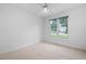 Neutral bedroom with large window, neutral carpet, and ceiling fan at 101 Deerwalk Ct, Cary, NC 27513