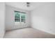 Bedroom with large window and neutral carpet at 101 Deerwalk Ct, Cary, NC 27513