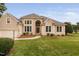 Elegant stucco home featuring manicured lawn, arched entryway, and bright, large windows at 101 Deerwalk Ct, Cary, NC 27513