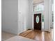 Bright foyer with hardwood flooring, striking front door with glass and sidelights, and high ceiling at 101 Deerwalk Ct, Cary, NC 27513