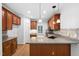 Well-equipped kitchen featuring wood cabinets, granite countertops, and stainless steel appliances at 101 Deerwalk Ct, Cary, NC 27513