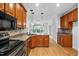 Spacious kitchen features wood cabinets, granite counters, and hardwood flooring at 101 Deerwalk Ct, Cary, NC 27513