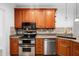 A traditional kitchen showcasing stainless steel appliances and wood cabinetry at 101 Deerwalk Ct, Cary, NC 27513