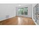 Bright living room with hardwood floors, large windows, and neutral paint at 101 Deerwalk Ct, Cary, NC 27513