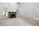 Bright living room with stone fireplace, carpet flooring, and ample natural light from large windows at 101 Deerwalk Ct, Cary, NC 27513