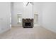 Open living room with stone fireplace, bright windows, plush carpeting and soaring ceilings at 101 Deerwalk Ct, Cary, NC 27513