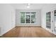 Bright living room boasts hardwood floors, large windows, and ceiling fan at 101 Deerwalk Ct, Cary, NC 27513