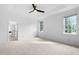 A spacious bedroom with ample natural light, ensuite bath, and ceiling fan at 101 Deerwalk Ct, Cary, NC 27513