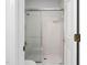Tiled shower with sliding glass door, toilet, and door at 101 Deerwalk Ct, Cary, NC 27513