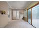Cozy sunroom featuring wood paneled walls, an exterior door, and large windows at 101 Deerwalk Ct, Cary, NC 27513