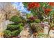Beautifully landscaped backyard with lush greenery, brick walkway and mature trees at 1012 Delta River Way, Knightdale, NC 27545